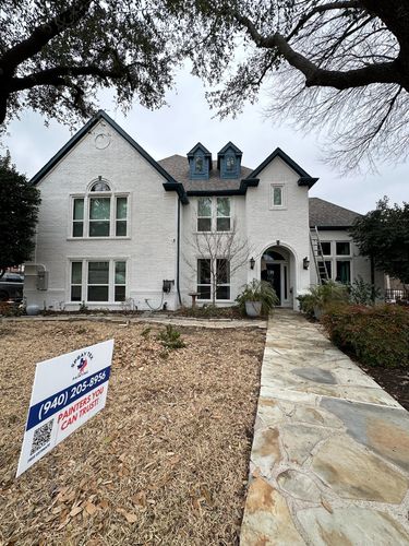A freshly-painted brick exterior by Spray Tex Painting