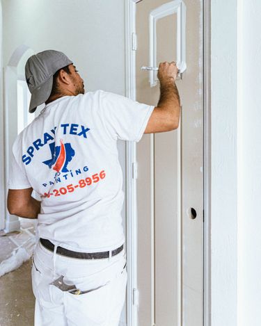 A Spray Tex Painting employee painting a door.
