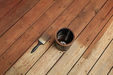 Semi-transparent stain being applied to a deck